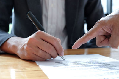 Cropped image of man working on table