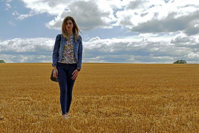 Full length of man standing on field against sky