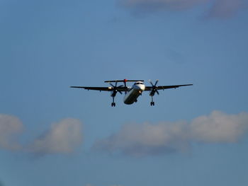 Low angle view of airplane flying in sky