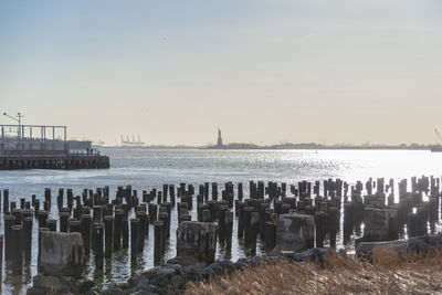 View of wooden posts in sea