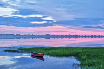 Red canoe floats in scenic maine coast