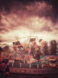 Low angle view of amusement park ride against sky