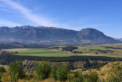 Scenic view of landscape and mountains against sky