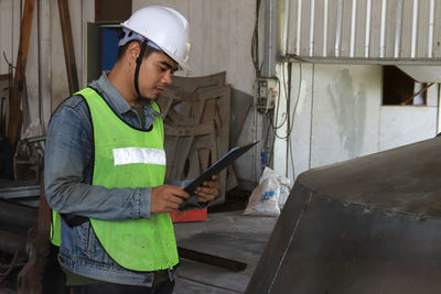 Mechanic engineer holding a note in the champagne bucket factory