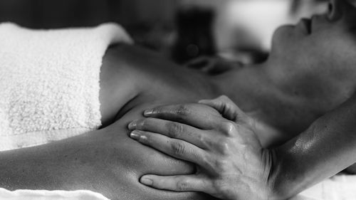 Woman enjoying ayurvedic shoulders massage with ethereal oils