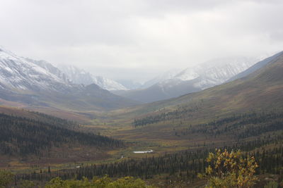 Scenic view of landscape and mountains against sky