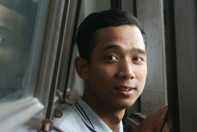 Close-up portrait of man against wall