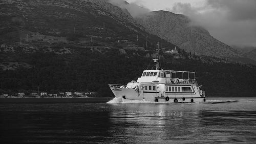 Ship sailing on sea against sky