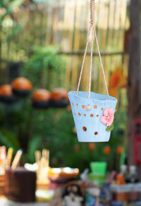 Close-up of decorated flower pot hanging at backyard