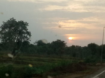 Scenic view of field against sky during sunset