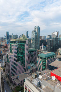 High angle view of buildings in city against sky