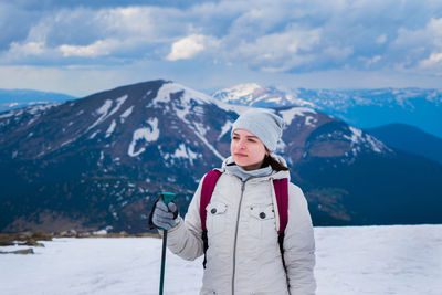 Woman standing on snow covered landscape