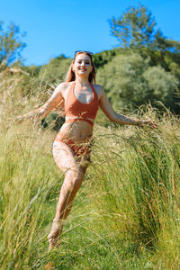 Full length of a young woman on field