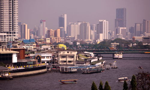View of harbor with buildings against sky