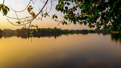 Scenic view of lake against sky at sunset