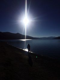 Sun shining through clouds over sea