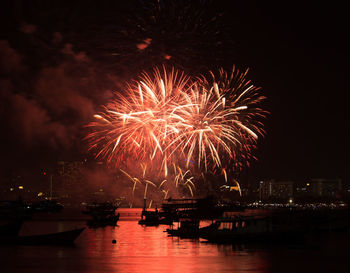 Firework display in city at night