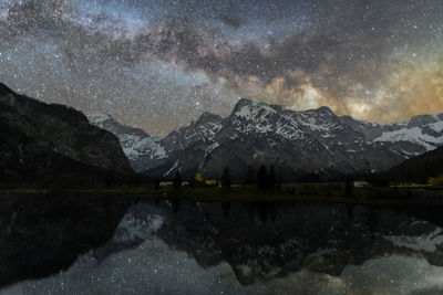 Scenic view of mountains against star field at night