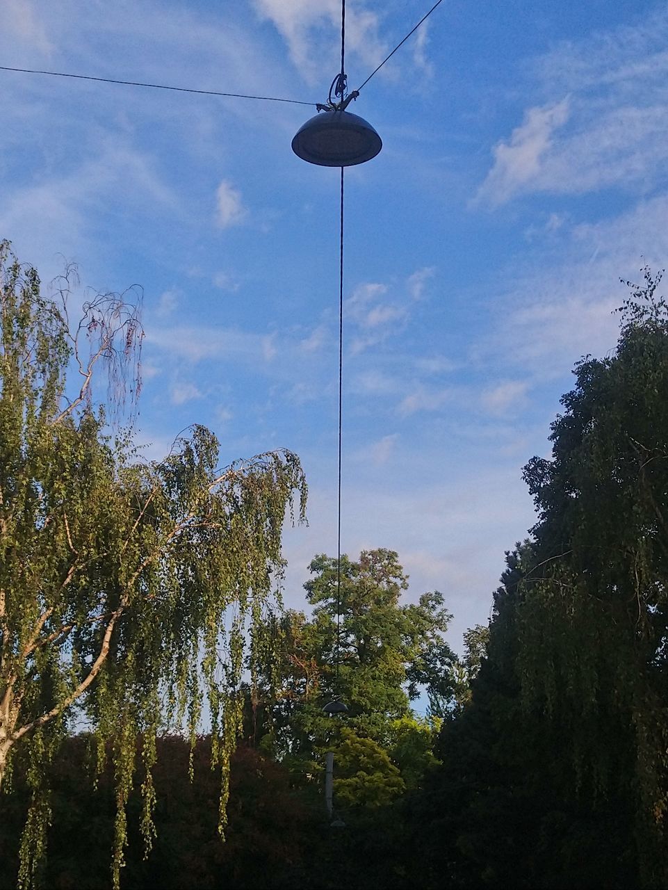 LOW ANGLE VIEW OF STREET LIGHTS HANGING AGAINST SKY