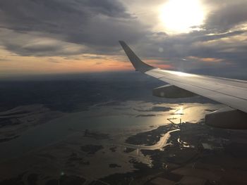 Aerial view of airplane wing over landscape