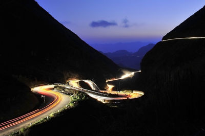 High angle view of light trails on mountain at night
