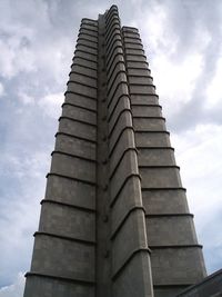 Low angle view of building against cloudy sky