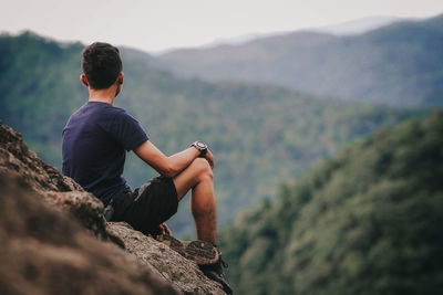 Rear view of man looking at mountain view