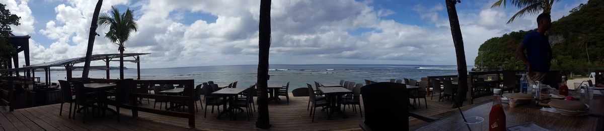 Panoramic view of restaurant by sea against sky