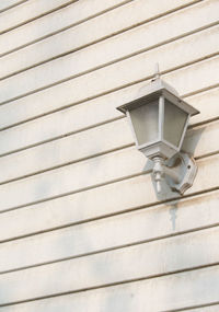 Low angle view of electric lamp on wall