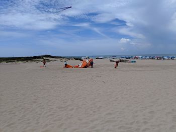 People on beach against sky