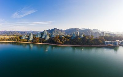 Scenic view of lake by mountains against sky