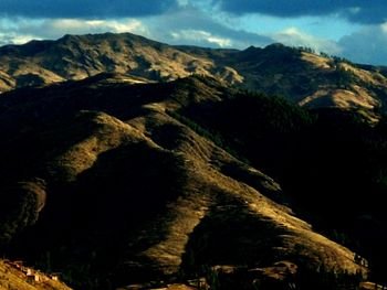 Scenic view of mountains against cloudy sky