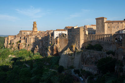 Pitigliano cityscape with buildings in early morning light in tuscany