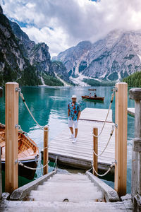 Scenic view of lake by snowcapped mountains against sky