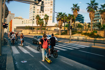 People riding motorcycle on city street