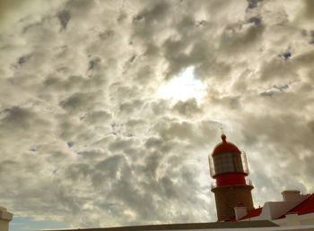 Low angle view of lighthouse against cloudy sky