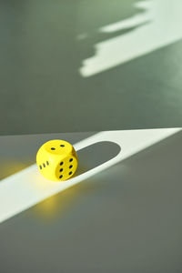 High angle view of yellow dice on table