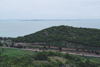 High angle view of land and sea against sky