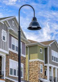 Low angle view of street light against building