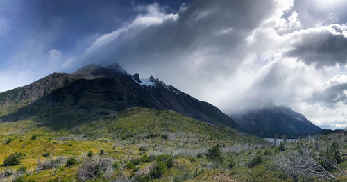 Scenic view of mountains against cloudy sky