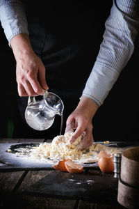 Midsection of man preparing food