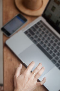 Close-up of person using laptop on table