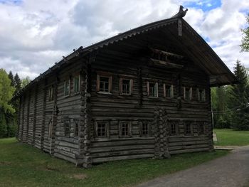 Exterior of old house on field against sky