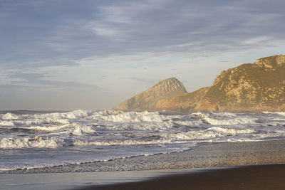 Scenic view of beach against sky during sunset