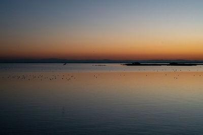 Scenic view of sea against sky at sunset