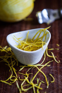 Close-up of shattered lemon in bowl on table