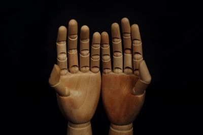 Close-up of human hand against black background