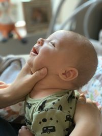 Woman touching baby boy at home