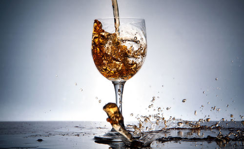 Close-up of pouring wine into glass