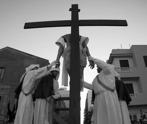 Low angle view of cross against sky